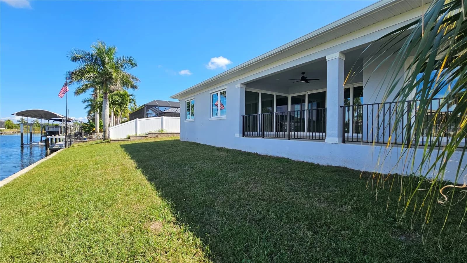 Rear elevation of a Coastal Pointe home with a covered lanai, private dock and boat lift