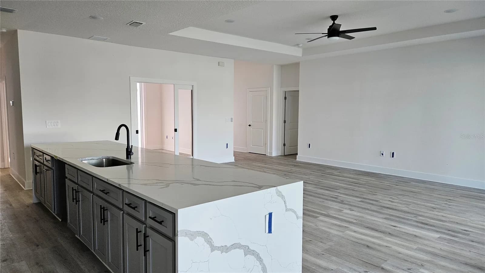 Kitchen island in a finished Coastal Pointe home, open to the great room